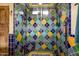 Vibrant bathroom shower with colorful tilework and glass enclosure at 6255 E Crocus Dr, Scottsdale, AZ 85254