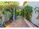 Inviting courtyard with tiled floors, overhead trellis, lush flowers and a quaint seating area at 6255 E Crocus Dr, Scottsdale, AZ 85254