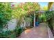 Lush courtyard with vibrant bougainvillea, tiled patio, and a cozy seating area at 6255 E Crocus Dr, Scottsdale, AZ 85254