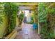 Tranquil outdoor courtyard features a bistro set and tiled walkway with lush landscaping at 6255 E Crocus Dr, Scottsdale, AZ 85254