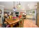 Open dining area showcasing decor, seamlessly connected to the kitchen with an adjacent fireplace at 6255 E Crocus Dr, Scottsdale, AZ 85254