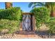 Rustic wooden gate surrounded by lush greenery, adding character and privacy to the property at 6255 E Crocus Dr, Scottsdale, AZ 85254