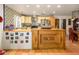 Well-lit kitchen with an island, tile backsplash, and stainless steel appliances at 6255 E Crocus Dr, Scottsdale, AZ 85254
