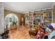 Eclectic living room with tiled floors, whitewashed bookshelves, and unique decor accents at 6255 E Crocus Dr, Scottsdale, AZ 85254