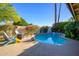 Backyard pool with mature landscaping and patio furniture, perfect for outdoor enjoyment at 6255 E Crocus Dr, Scottsdale, AZ 85254