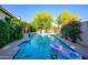 Private backyard pool surrounded by lush landscaping and mature trees, perfect for relaxation at 6255 E Crocus Dr, Scottsdale, AZ 85254