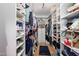 Well-organized walk-in closet with shelves and clothing racks, maximizing storage space at 6255 E Crocus Dr, Scottsdale, AZ 85254