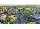 Aerial view of the neighborhood and community entrance, showcasing lush trees and landscaping at 7525 E Gainey Ranch Rd # 164, Scottsdale, AZ 85258
