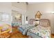 Well-lit bedroom with two twin beds, mirrored closet, hardwood floors, and vaulted ceiling at 7525 E Gainey Ranch Rd # 164, Scottsdale, AZ 85258