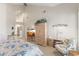 Bright bedroom featuring high ceilings, wardrobe, vanity, sitting area, and floral bedding at 7525 E Gainey Ranch Rd # 164, Scottsdale, AZ 85258