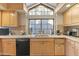 Eat-in kitchen with granite countertops, light wood cabinetry, and stainless steel appliances at 7525 E Gainey Ranch Rd # 164, Scottsdale, AZ 85258
