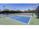 Multiple pickleball courts surrounded by lush landscaping for outdoor recreation at 7525 E Gainey Ranch Rd # 164, Scottsdale, AZ 85258