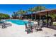 Inviting community pool area with lounge chairs, palm trees, and shaded seating at 7525 E Gainey Ranch Rd # 164, Scottsdale, AZ 85258