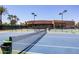 Well-maintained tennis court with vibrant blue surface and lush landscaping at 7525 E Gainey Ranch Rd # 164, Scottsdale, AZ 85258