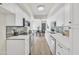 Well-lit kitchen featuring white cabinets, stainless steel appliances, and breakfast area at 7835 N 21St Dr, Phoenix, AZ 85021