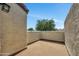 Private patio with textured stucco walls and a view of mature trees at 7835 N 21St Dr, Phoenix, AZ 85021