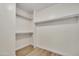 Bright walk-in closet features built in shelves and light wood flooring at 7835 N 21St Dr, Phoenix, AZ 85021