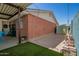 View of a brick home, backyard patio with a storage shed, and an outdoor space at 8155 E Columbus Ave, Scottsdale, AZ 85251