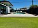 Inviting backyard with a modern pool, lounge chairs, and a well-maintained artificial lawn for relaxation at 8155 E Columbus Ave, Scottsdale, AZ 85251
