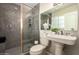 Bathroom featuring a glass-enclosed shower and a pedestal sink with fixtures at 8155 E Columbus Ave, Scottsdale, AZ 85251