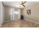 Bedroom featuring a ceiling fan, window with coverings, and stylish tile flooring at 8155 E Columbus Ave, Scottsdale, AZ 85251