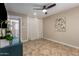 Bedroom featuring a ceiling fan, neutral walls, and tile floors throughout at 8155 E Columbus Ave, Scottsdale, AZ 85251