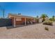 Low-angle view of a brick home with a covered carport and desert landscaping at 8155 E Columbus Ave, Scottsdale, AZ 85251