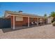 Low-angle view of a brick home with a covered carport and desert landscaping at 8155 E Columbus Ave, Scottsdale, AZ 85251