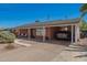 A single-story brick home featuring a covered carport and xeriscaped front yard at 8155 E Columbus Ave, Scottsdale, AZ 85251