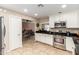 Well-equipped kitchen with stainless steel appliances and an open view to the dining area at 8155 E Columbus Ave, Scottsdale, AZ 85251