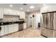 Bright kitchen with stainless steel appliances, white cabinetry and granite countertops at 8155 E Columbus Ave, Scottsdale, AZ 85251