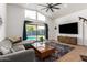 Contemporary living room with vaulted ceilings, hardwood floors, and view of the pool at 8155 E Columbus Ave, Scottsdale, AZ 85251