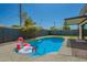 Refreshing swimming pool with sun umbrellas and fun inflatable floats, surrounded by a well-maintained patio area at 8155 E Columbus Ave, Scottsdale, AZ 85251