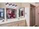 Bathroom featuring dual sinks, white cabinets, and a framed mirror at 8355 E Vía De Los Libros --, Scottsdale, AZ 85258