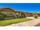 Charming brick house with a manicured lawn and an attached garage under a clear blue sky at 8355 E Vía De Los Libros --, Scottsdale, AZ 85258