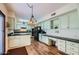 Spacious kitchen with wood flooring, a built-in desk area, and ample cabinet space at 8355 E Vía De Los Libros --, Scottsdale, AZ 85258