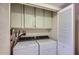 Convenient laundry area with appliances, storage cabinets, and tiled flooring at 8355 E Vía De Los Libros --, Scottsdale, AZ 85258