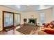 Cozy living room featuring a fireplace, wood floors, and sliding door to outdoor area at 8355 E Vía De Los Libros --, Scottsdale, AZ 85258