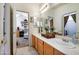 Bathroom with a double sink vanity, tiled flooring, and neutral colors at 9038 E Calle De Valle Dr, Scottsdale, AZ 85255