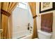 Bathroom with a white toilet, a white tub, and a towel rack at 9038 E Calle De Valle Dr, Scottsdale, AZ 85255