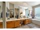 Bright bathroom featuring double sinks, tiled flooring, and a separate tub at 9038 E Calle De Valle Dr, Scottsdale, AZ 85255