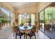 Sunlit breakfast nook with glass table, stylish chairs, and picturesque backyard views at 9038 E Calle De Valle Dr, Scottsdale, AZ 85255