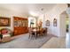 Traditional dining room with an elegant table set, classic hutch, and a cozy wicker chair at 9038 E Calle De Valle Dr, Scottsdale, AZ 85255