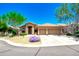Lovely home exterior features a well-maintained yard with mature trees and a convenient two-car garage at 9038 E Calle De Valle Dr, Scottsdale, AZ 85255