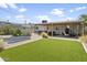 Well-manicured backyard with a shed, patio area, lawn, and stylish landscaping at 912 E Orchid Ln, Phoenix, AZ 85020