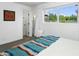 Bedroom showcasing a window with a view, closet access, and warm-colored blanket at 912 E Orchid Ln, Phoenix, AZ 85020