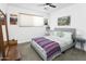 Cozy bedroom with a comfortable bed, soft lighting, and a colorful blanket with travel-themed wall art at 912 E Orchid Ln, Phoenix, AZ 85020