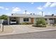 Single-story house featuring desert landscaping, a covered carport, and light-colored exterior at 912 E Orchid Ln, Phoenix, AZ 85020