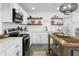 Well-lit kitchen with white cabinets, stainless steel appliances, and a central island at 912 E Orchid Ln, Phoenix, AZ 85020