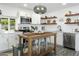 Kitchen with white cabinets, stainless steel appliances, and a wood island with seating at 912 E Orchid Ln, Phoenix, AZ 85020